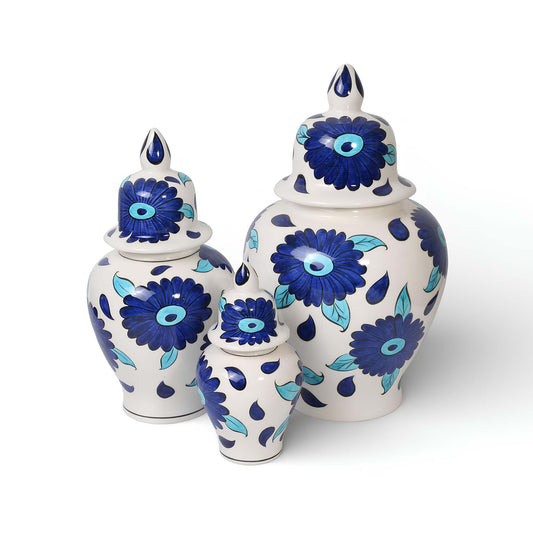 Set of three ceramic jars with blue floral patterns on a white background
