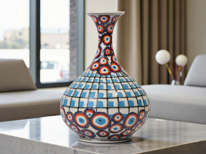 Decorative vase with circular patterns on a table in a modern living room.