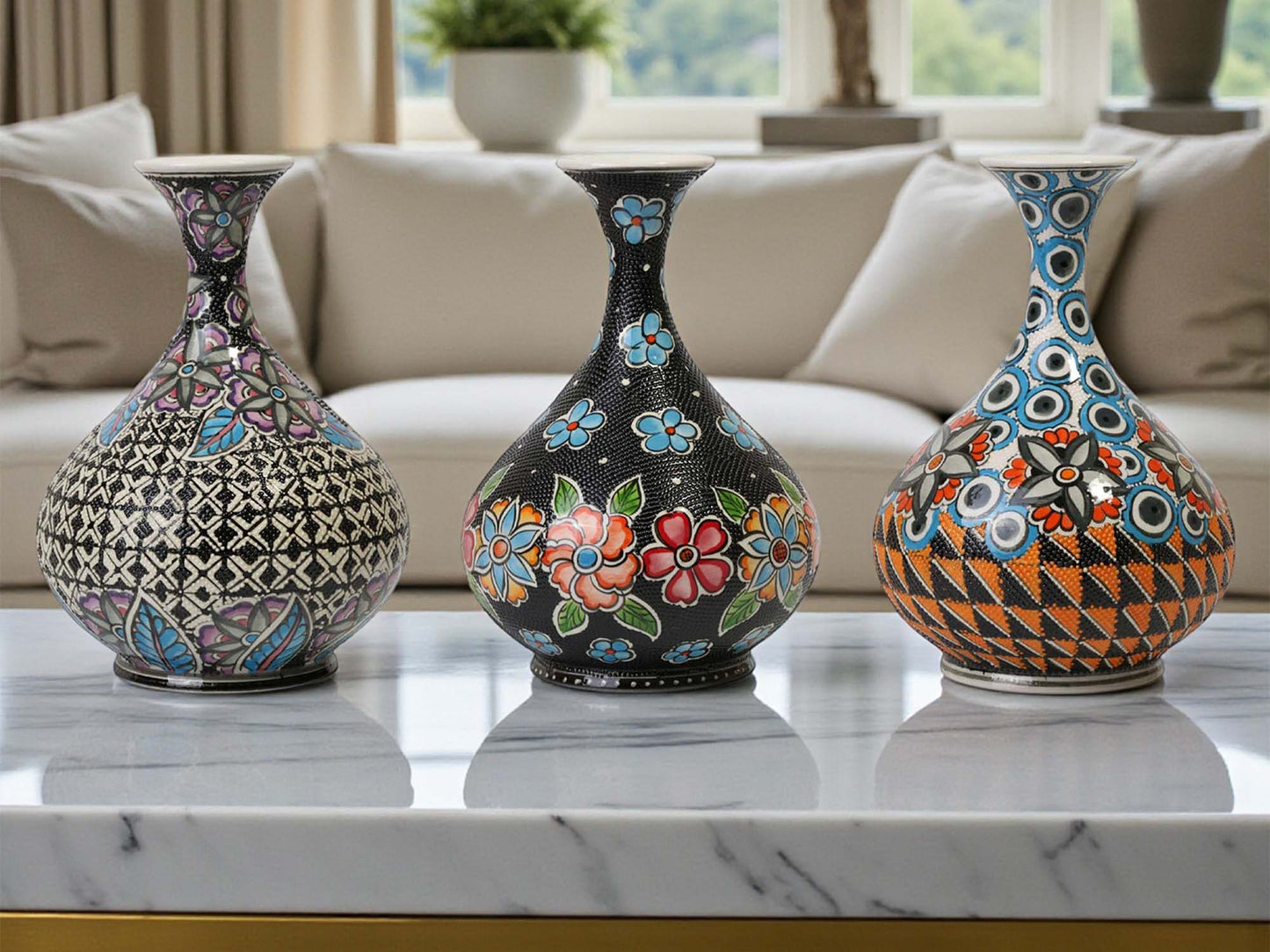 Three decorative vases with intricate patterns on a marble surface.