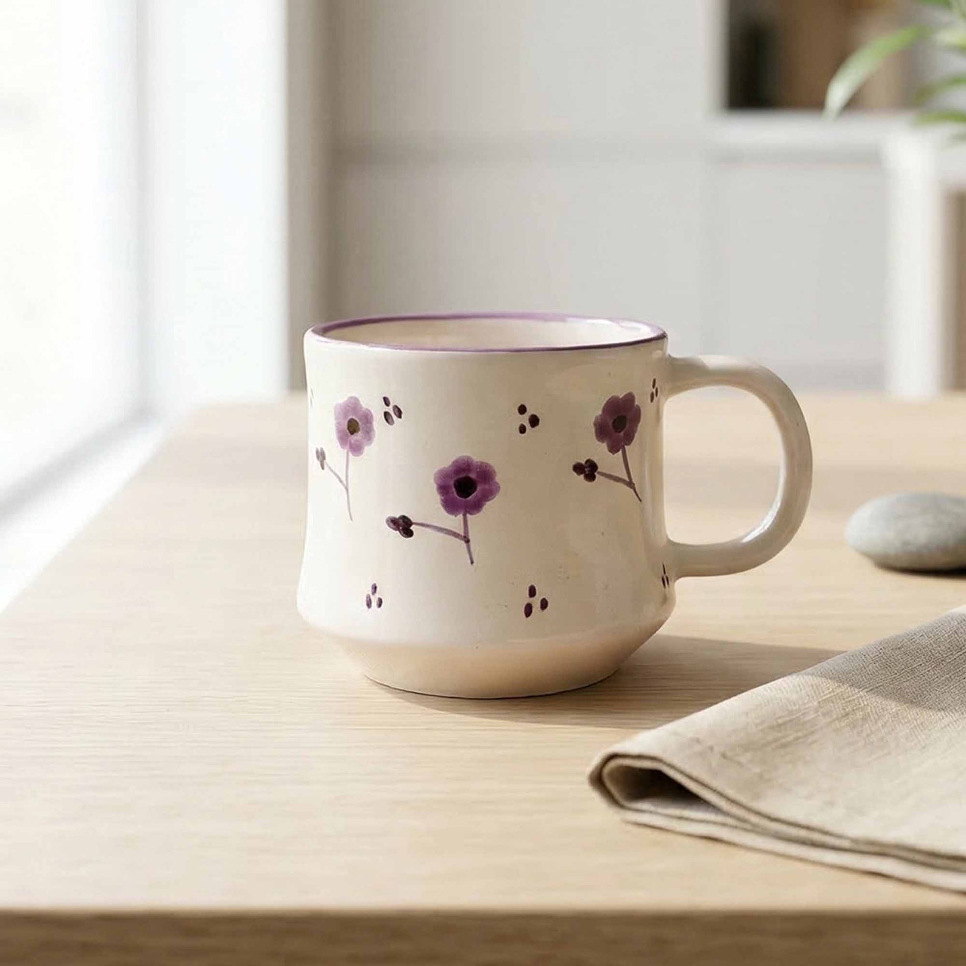 Ceramic mug with floral design on a wooden table