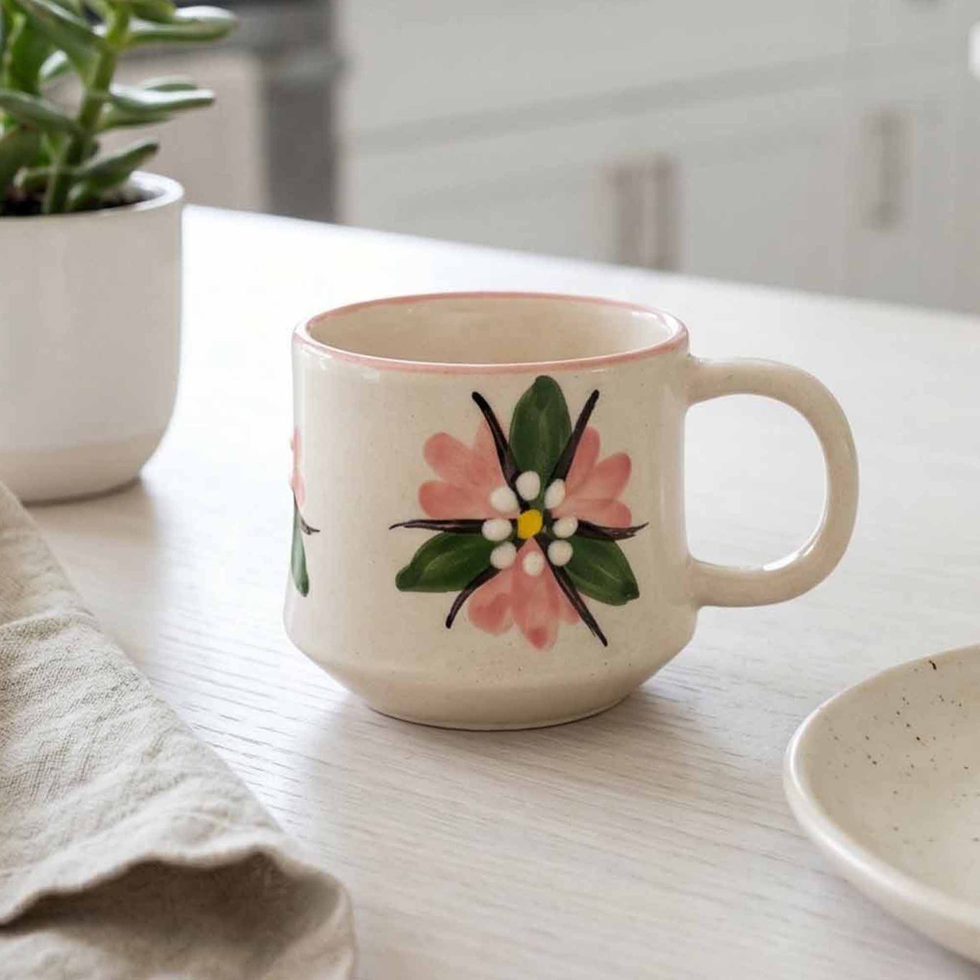 Ceramic mug with floral design on a kitchen counter