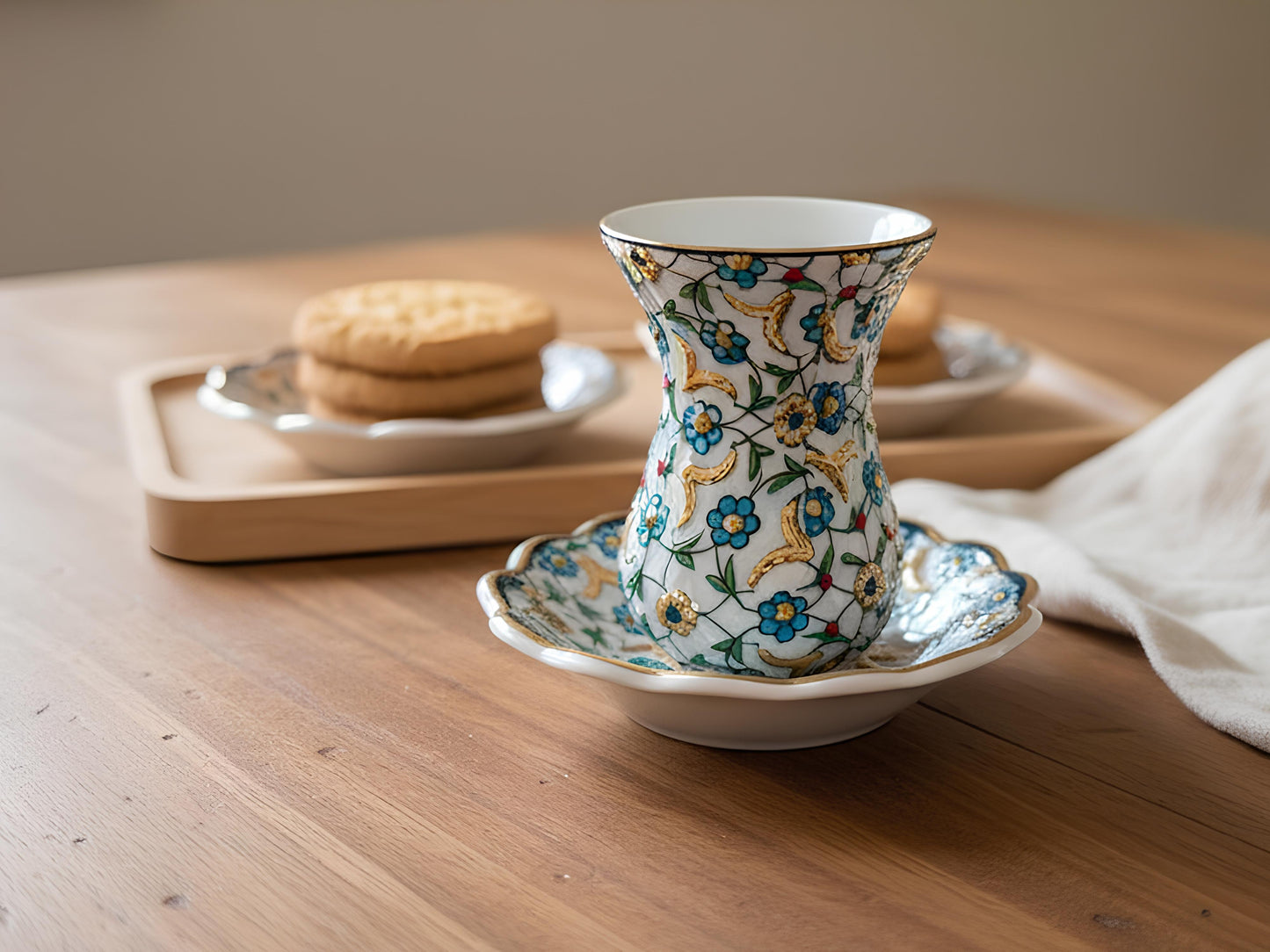 Decorative ceramic cup with floral patterns on a wooden table.