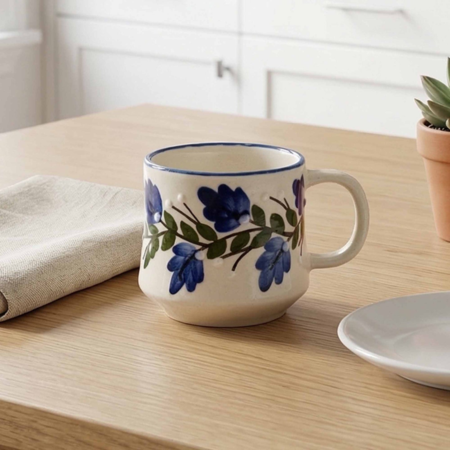 Ceramic mug with floral design on a wooden table