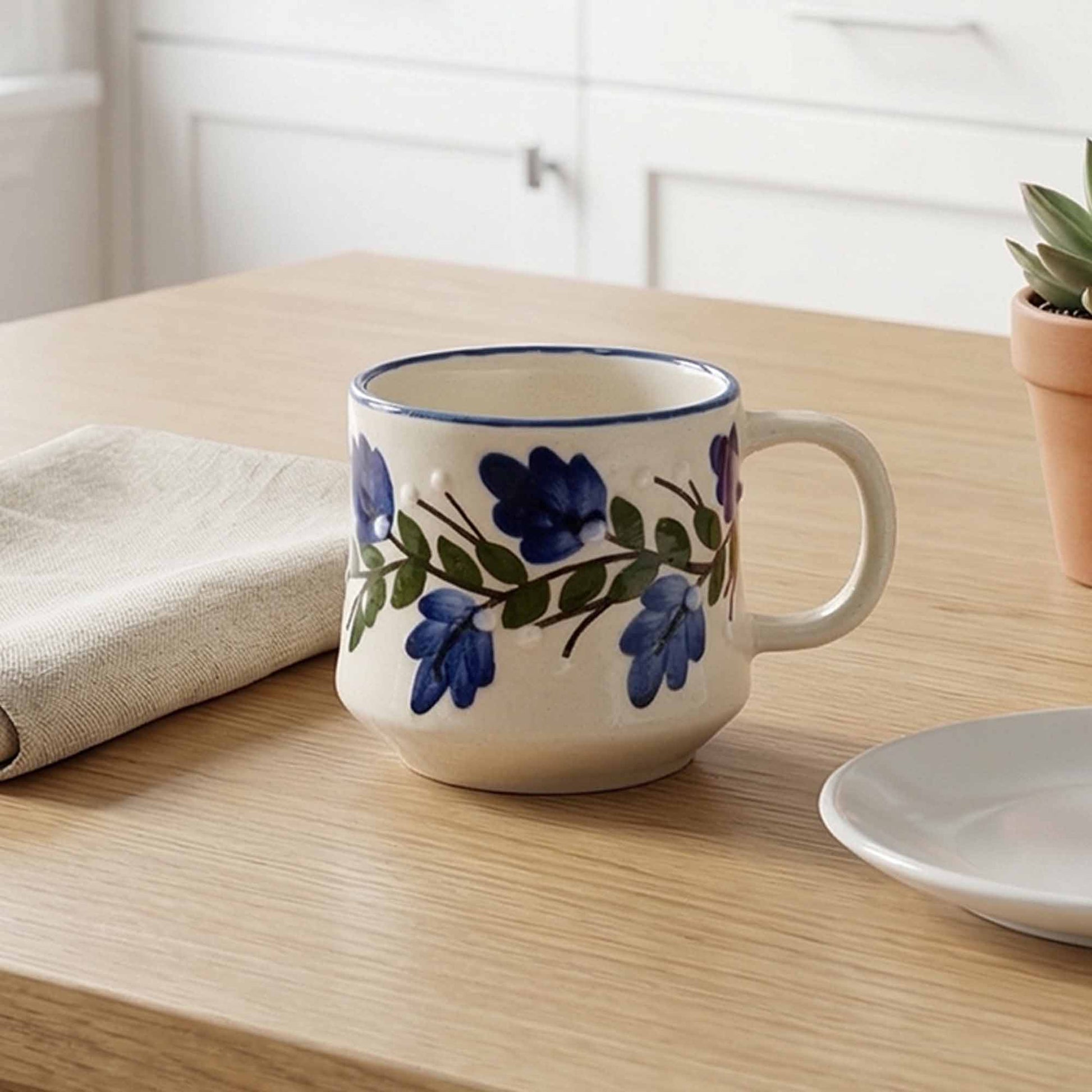 Ceramic mug with floral design on a wooden table