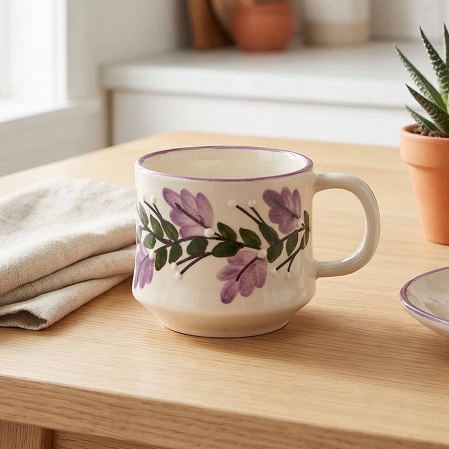 Ceramic mug with floral design on a wooden surface