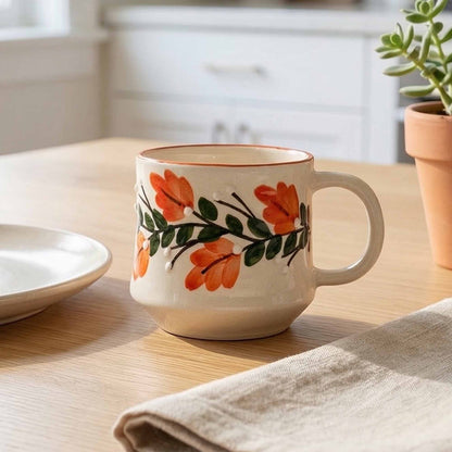Ceramic mug with floral design on a wooden table