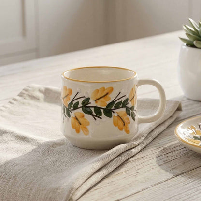 Ceramic mug with floral design on a wooden surface