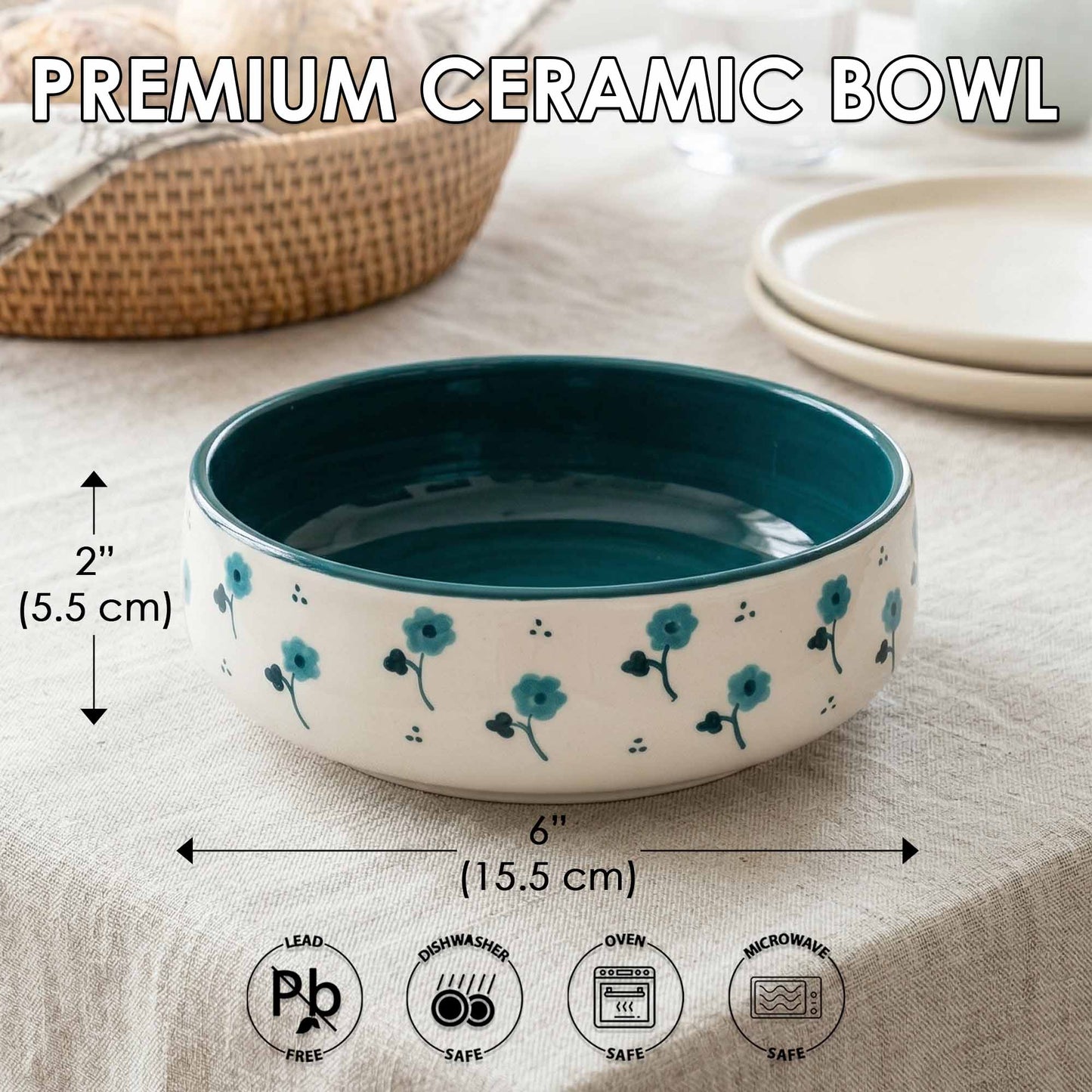 Teal and white ceramic bowl with floral design on a beige surface, showing measurements and safety icons.