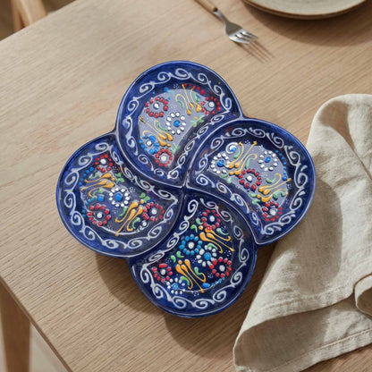 Decorative blue serving tray with colorful patterns on a wooden table.