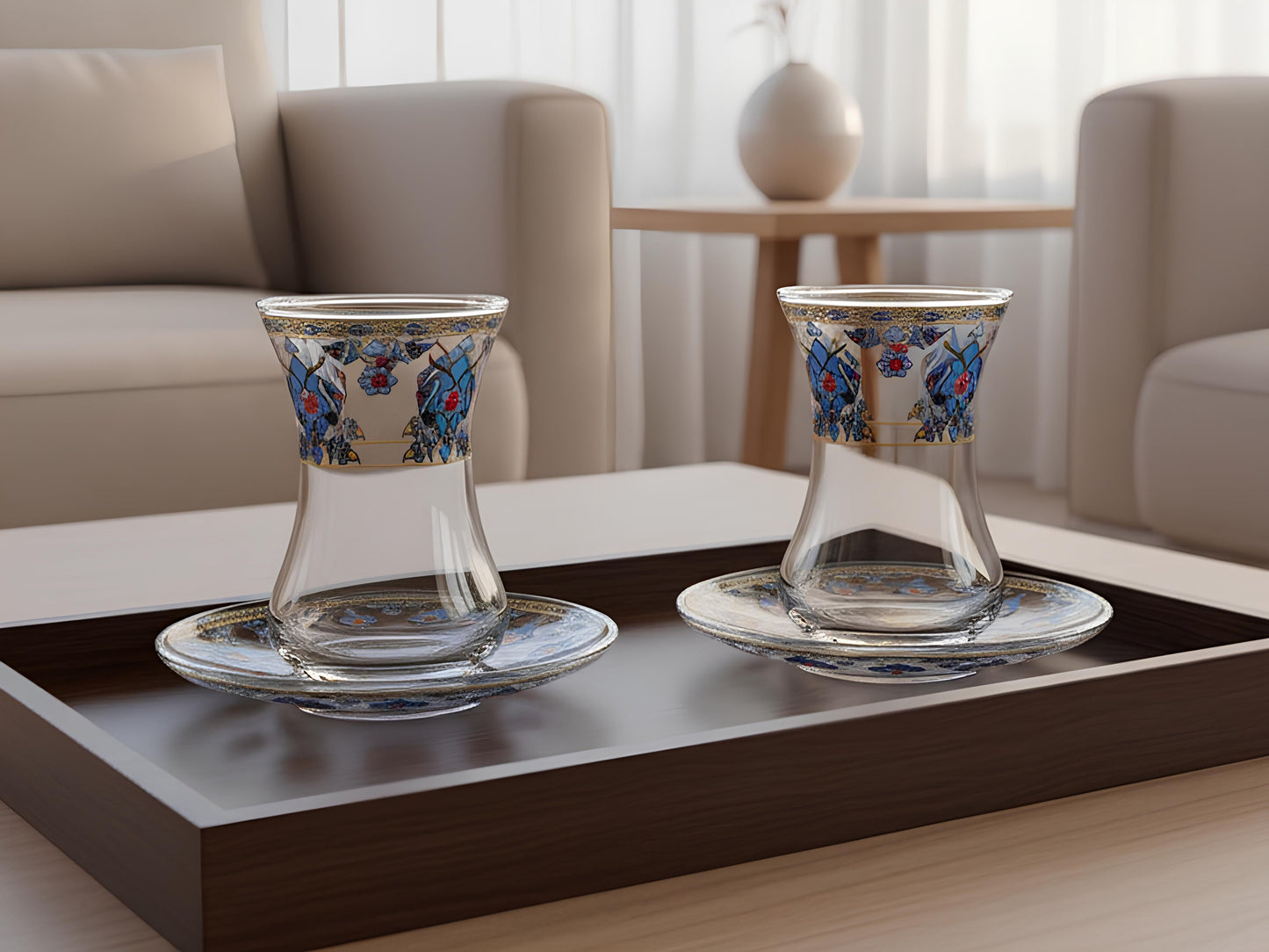 Two glass cups with floral designs on a dark wooden tray in a living room setting.