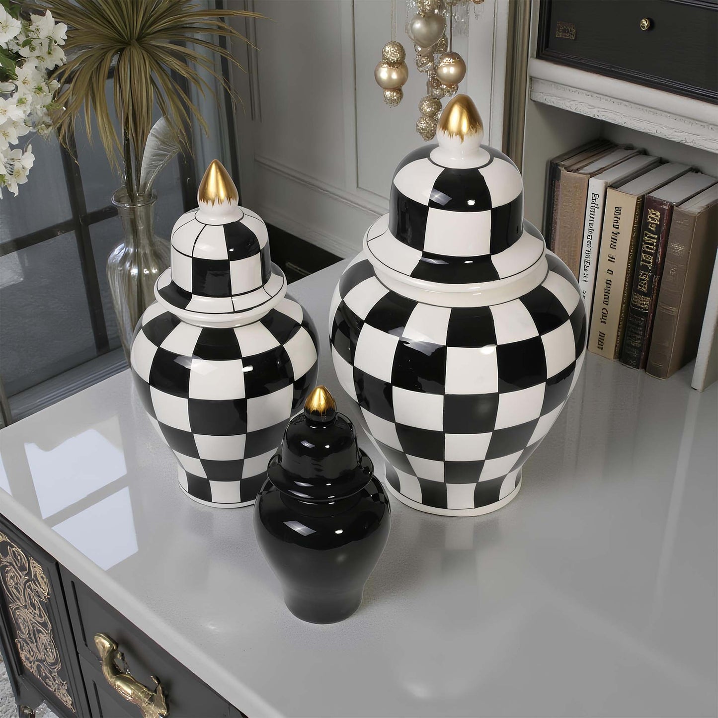Black and white checkered urns with gold accents on a reflective surface.