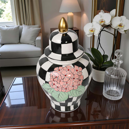 Decorative black and white checkered jar with floral design on a table in a living room.