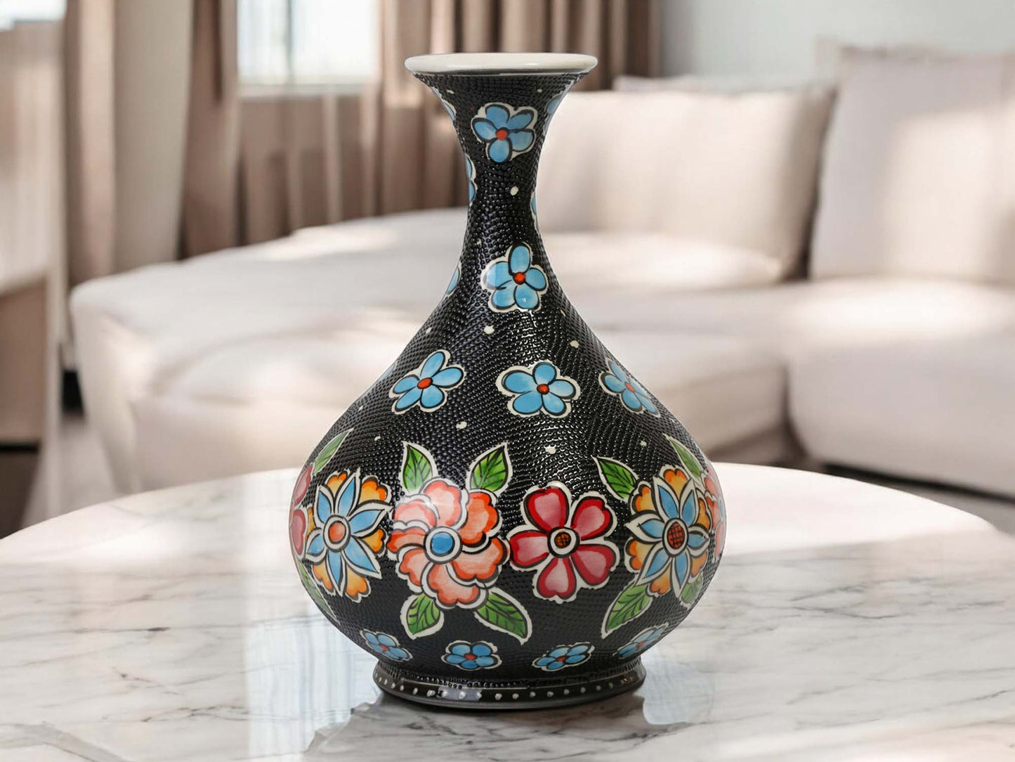 Decorative vase with floral patterns on a marble surface in a living room setting