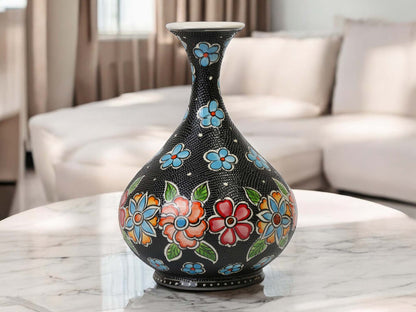 Decorative vase with floral patterns on a marble surface in a living room setting