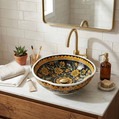 Decorative floral-patterned ceramic sink in a bathroom setting with a mirror and toiletries.