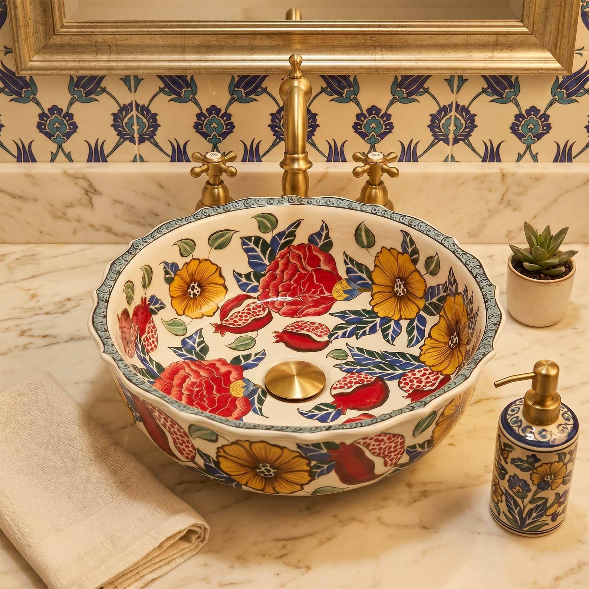Decorative floral-patterned ceramic sink with gold fixtures on a marble countertop.