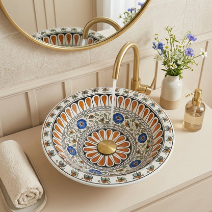 Decorative ceramic sink with floral patterns in a bathroom setting.