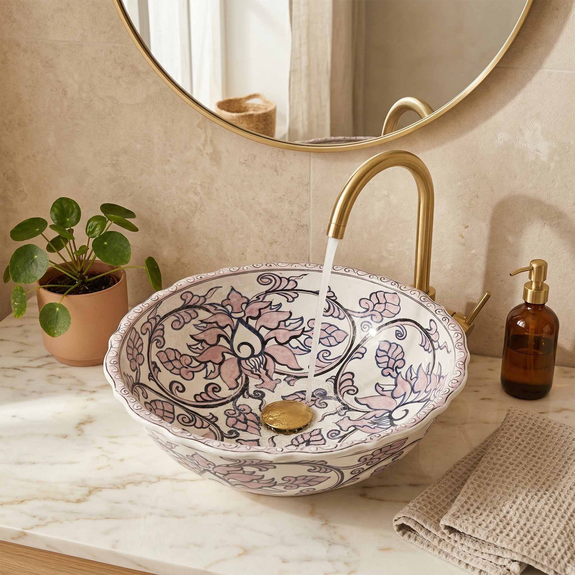 Decorative ceramic sink with floral patterns in a bathroom setting.