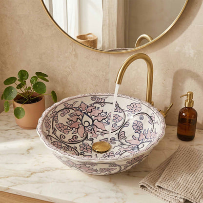Decorative ceramic sink with floral patterns in a bathroom setting.