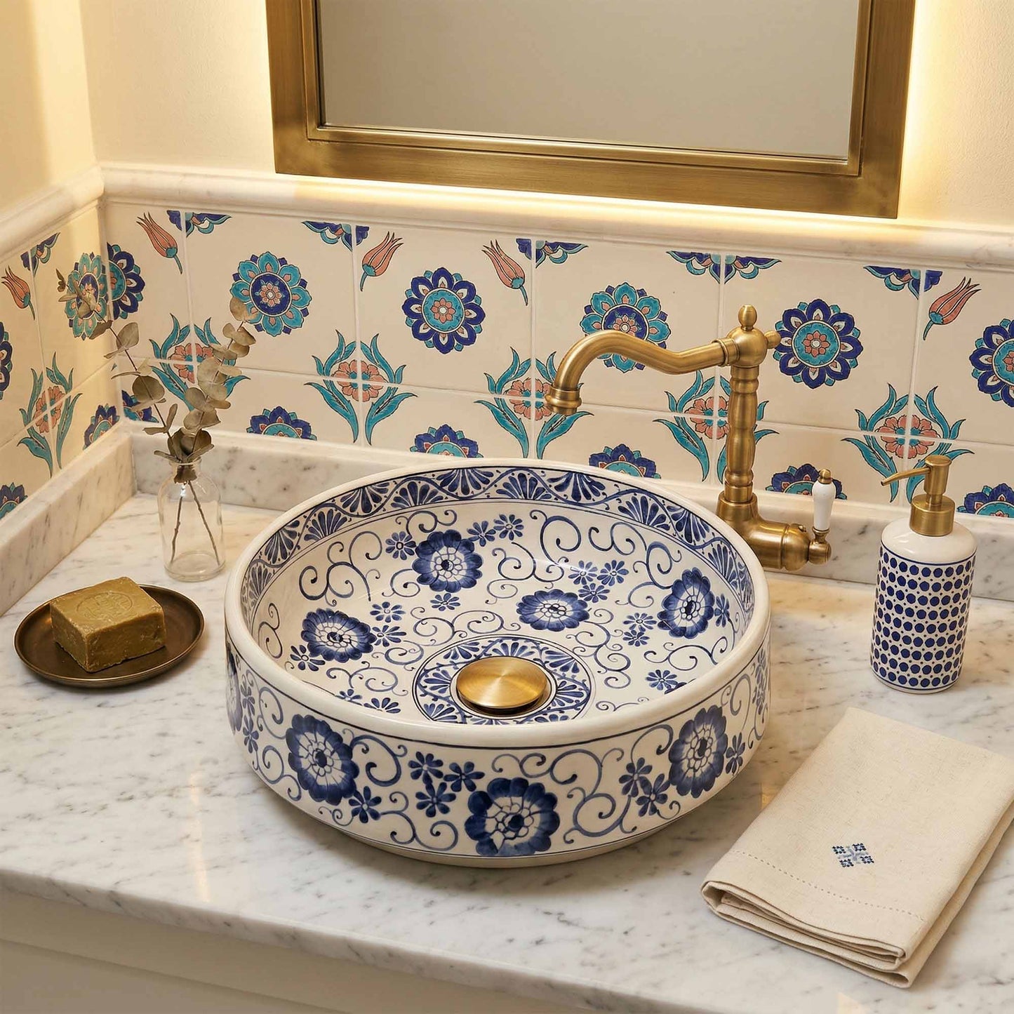 Decorative ceramic sink with blue floral patterns in a bathroom setting.
