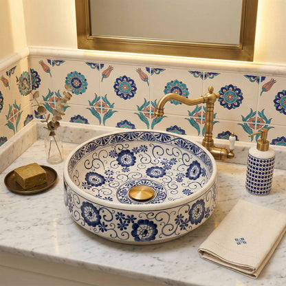 Decorative ceramic sink with blue floral patterns in a bathroom setting.