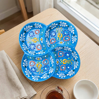 Decorative blue serving plate with floral patterns on a wooden table.