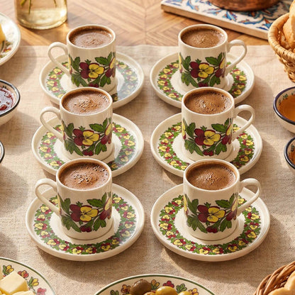 Set of porcelain coffee cups with floral patterns on a table.
