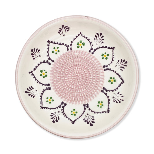 Decorative garlic grater bowl with pink center and floral patterns on a white background