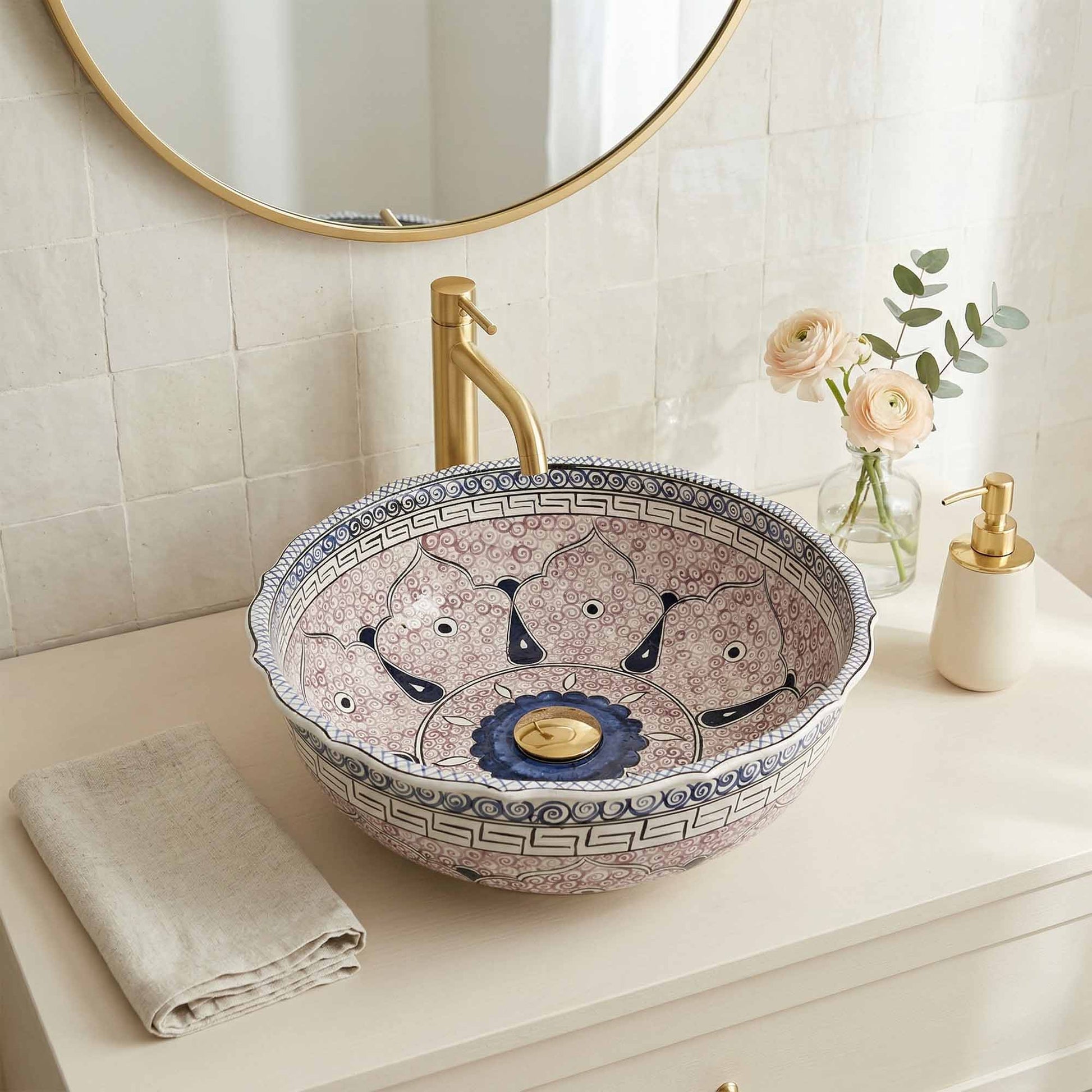 Decorative bathroom sink with artistic design on a countertop.