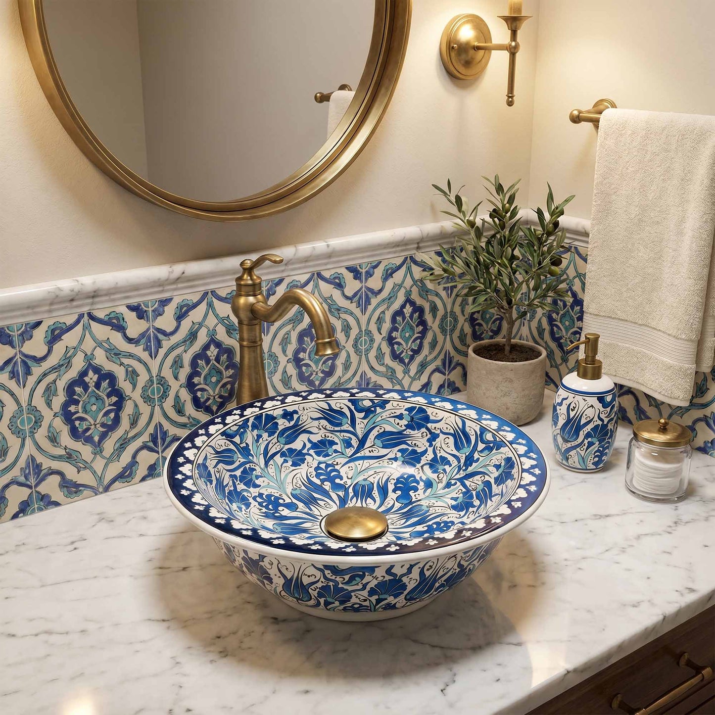 Decorative blue and white sink with gold fixtures in a bathroom setting.
