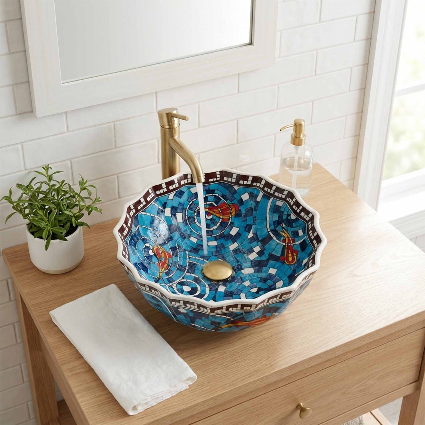 Decorative ceramic sink on a wooden vanity with a plant and soap dispenser.