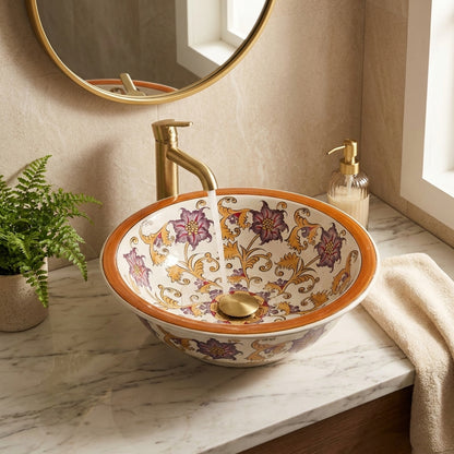 Decorative bathroom sink with floral patterns on a marble countertop.