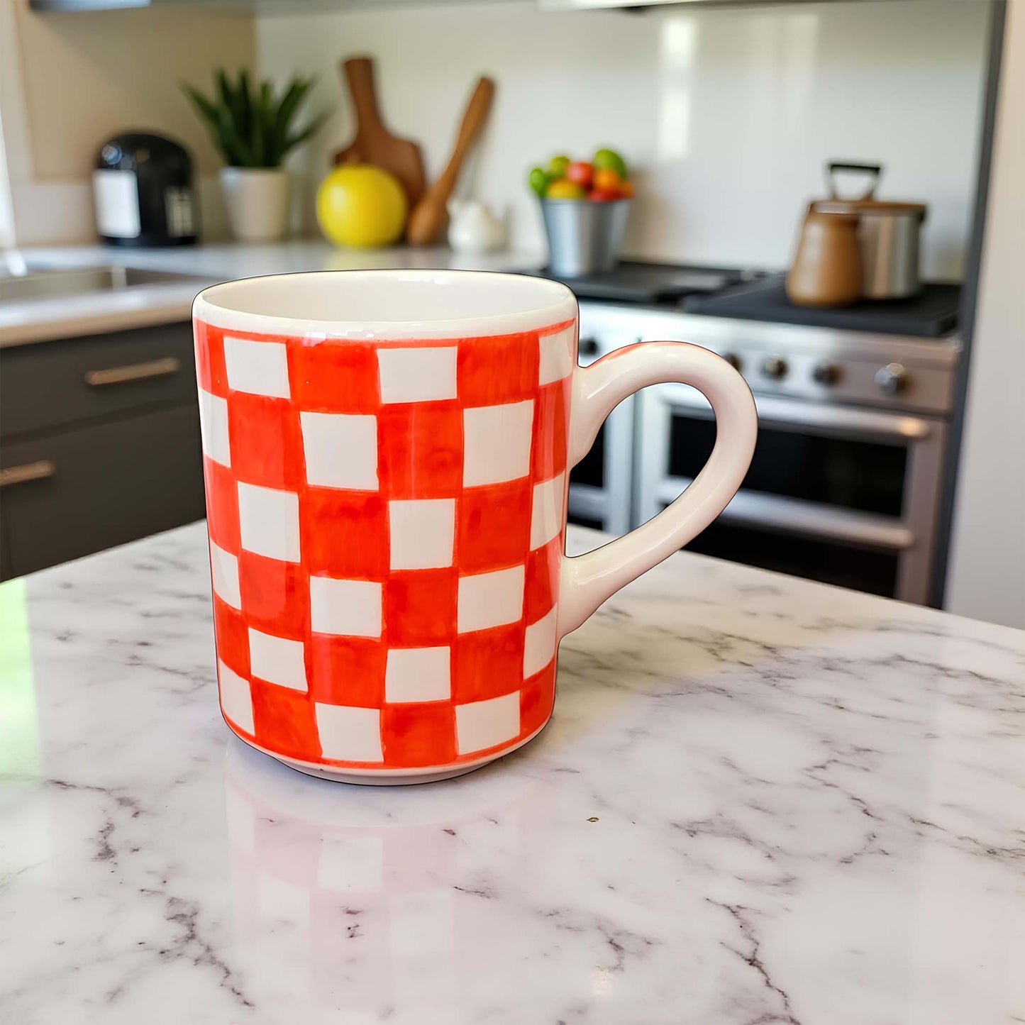 Red and white checkered mug on a marble countertop with a kitchen background
