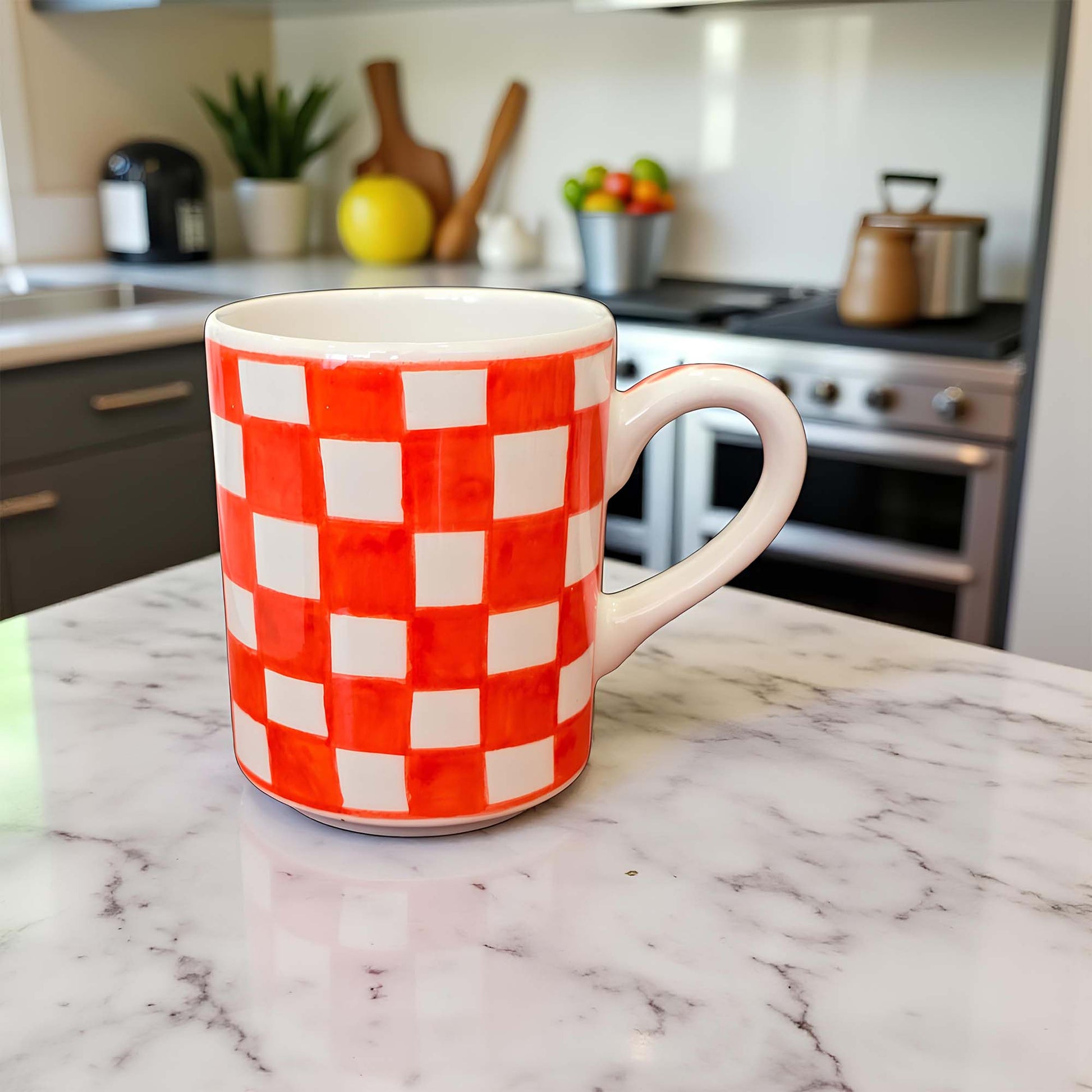 Red and white checkered mug on a marble countertop with a kitchen background