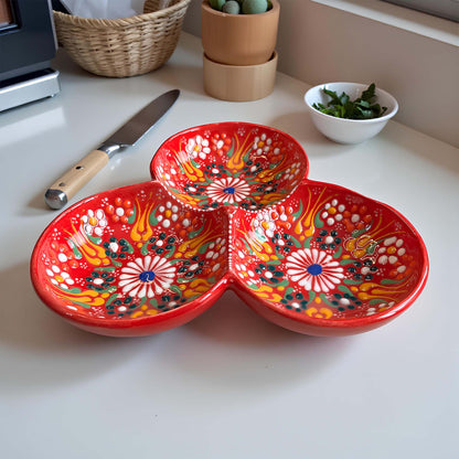 Colorful ceramic bowls on a kitchen counter with a knife and small bowl of greens.