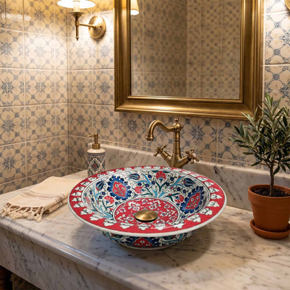 Decorative ceramic sink with floral patterns in a bathroom setting.