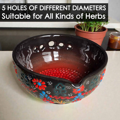Decorative ceramic herb stripping bowl with floral patterns on a table, text indicating different hole sizes for herbs.