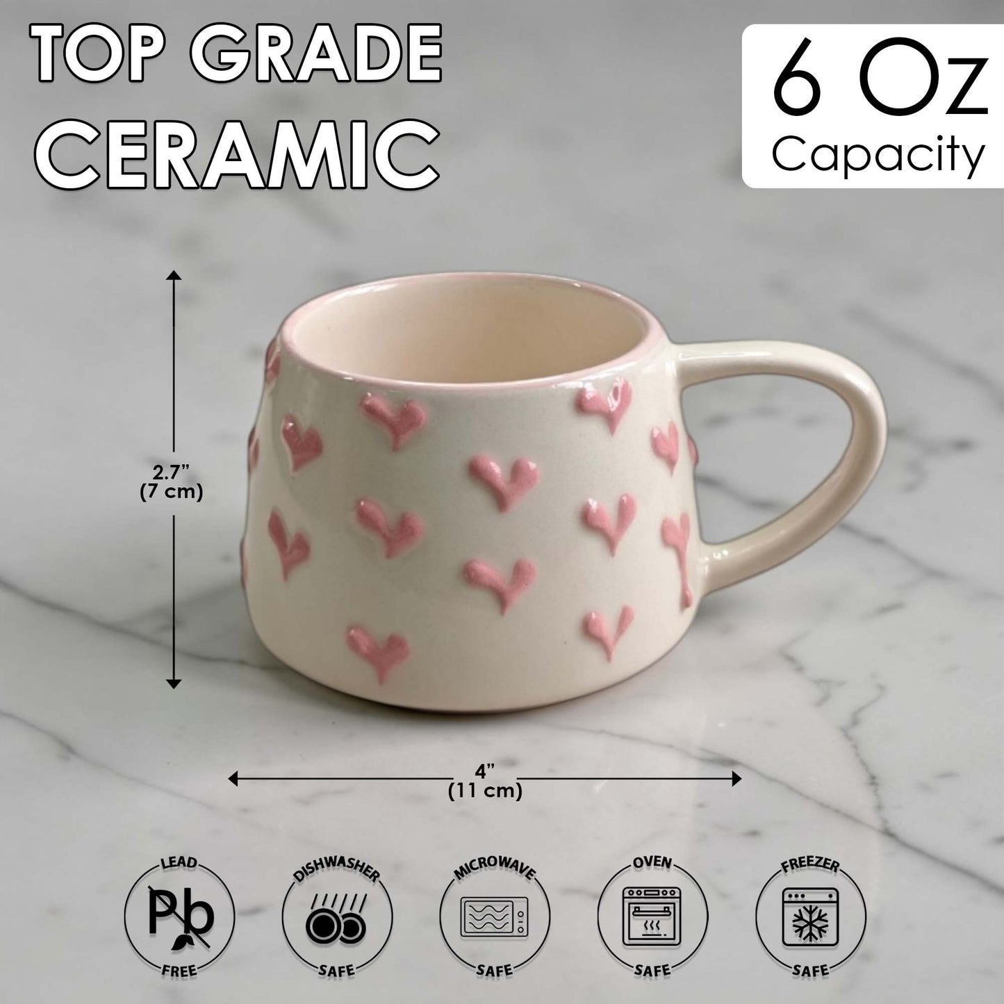 Ceramic mug with pink heart patterns on a marble surface, showing measurements and safety icons.