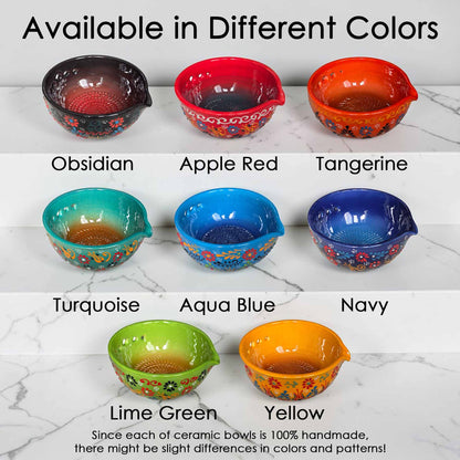 Set of ceramic bowls in various colors on a marble surface