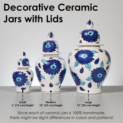 Decorative ceramic jars with lids of different sizes on a gray surface.