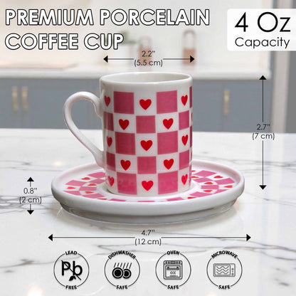 White coffee cup with red heart pattern on a matching saucer, with measurements and safety icons displayed.