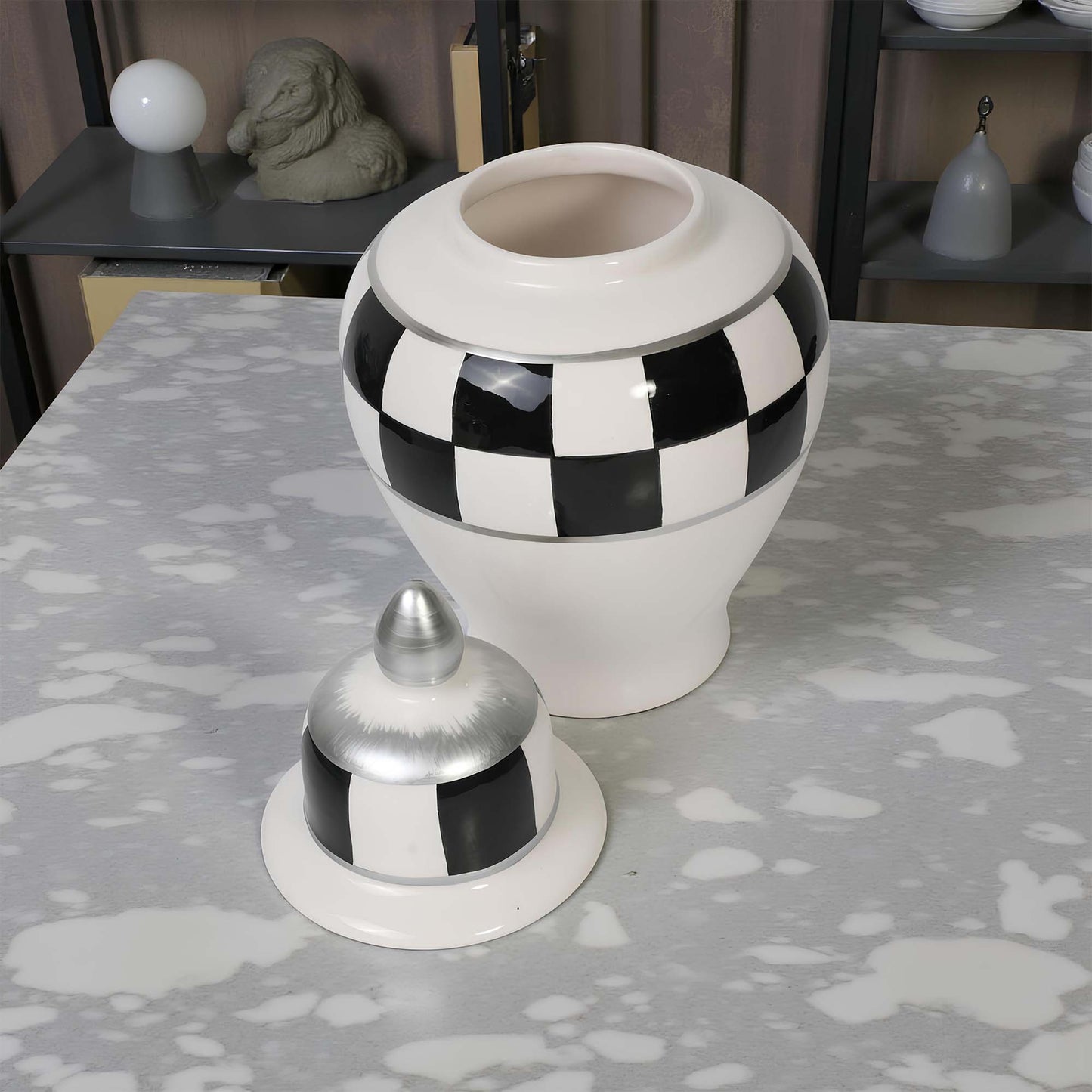 Decorative jar with checkered pattern on a textured surface