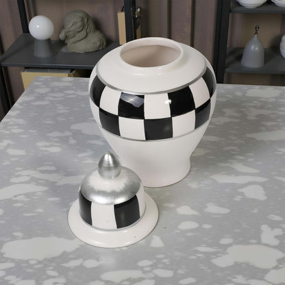 Decorative jar with checkered pattern on a textured surface