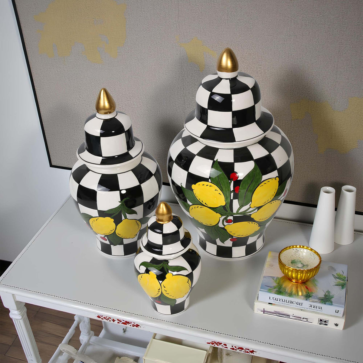 Decorative jarss with black and white checkered pattern and lemon design on a table.