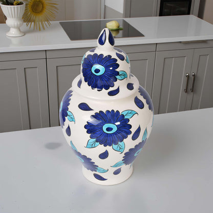 Decorative ceramic jar with blue floral patterns on a kitchen counter.