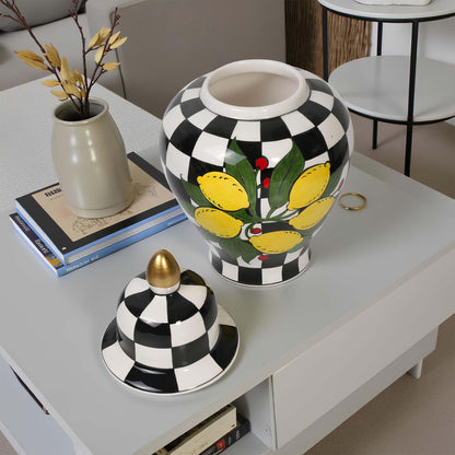 Decorative jar with checkered pattern and floral design on a table.