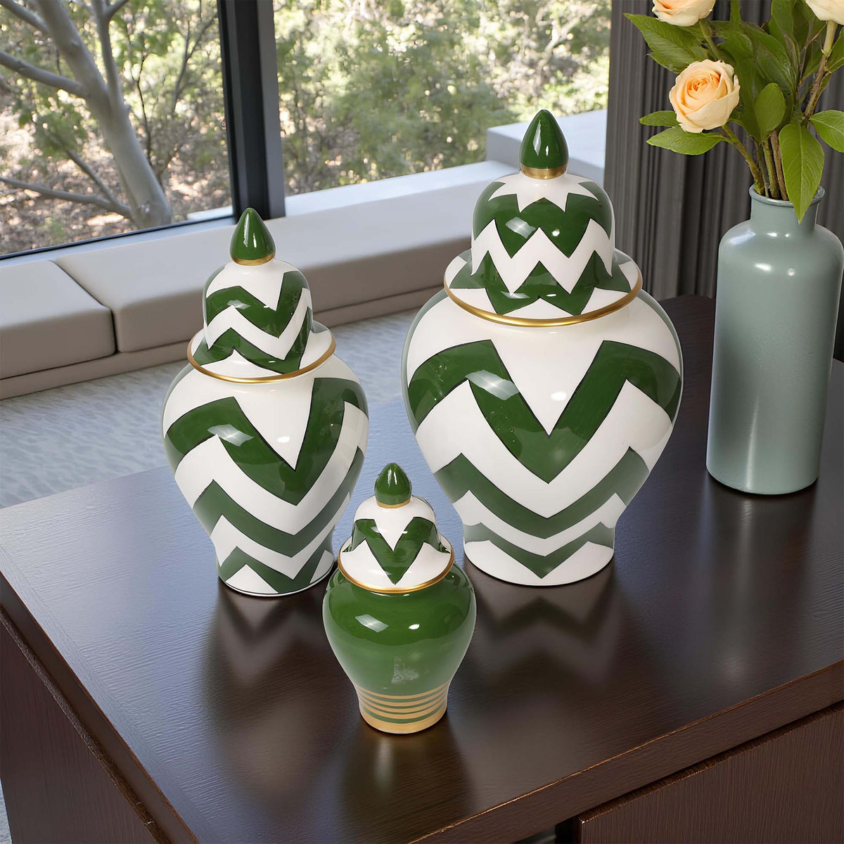 Set of green and white zigzag patterned jars on a wooden surface with a blurred indoor background.