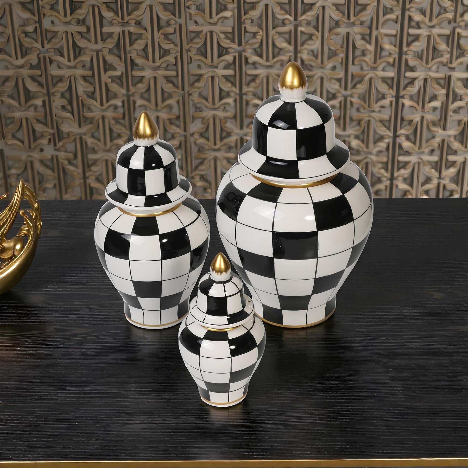 Set of black and white checkered jars with gold accents on a dark surface.