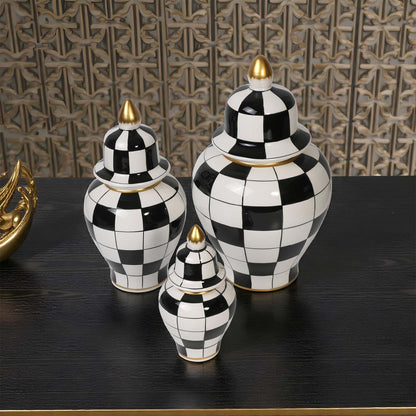 Set of black and white checkered jars with gold accents on a dark surface.