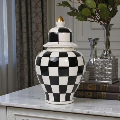 Black and white checkered vase on a marble surface with decorative books and vases in the background.